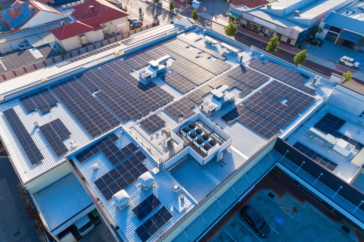 aerial views over commercial building with over 600 solar panels installed