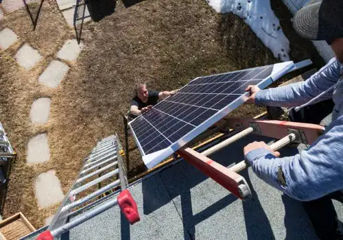 solar panel installation transporting modules to roof picture id955105504.jpg