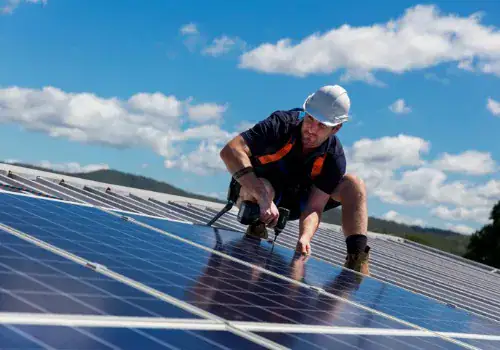 solar panel installer with drill installing solar panels picture id948327168.jpg