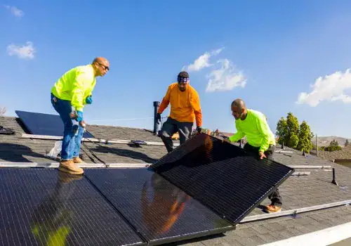 team of workers installing solar panels on residential rooftop in picture id1303756984.jpg